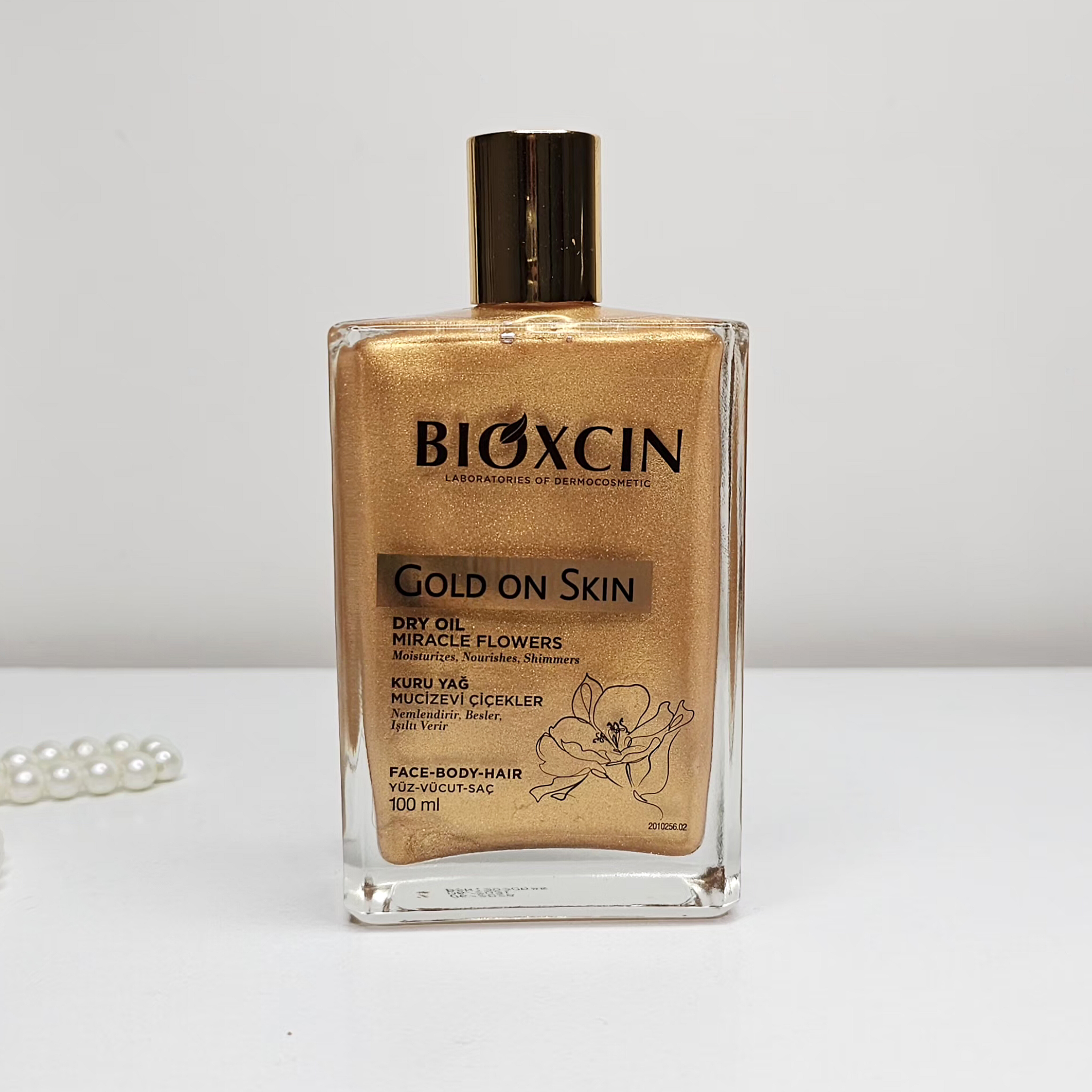 روغن مرطوب کننده و شاین صورت و بدن و مو بیوکسین Bioxin مدل Gold On Skin حجم 100 میل